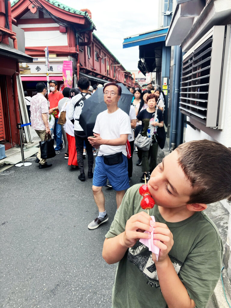 kids eating snacks at nakamise-dori at sensoji temple in tokyo